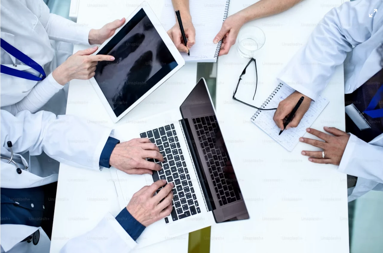 Medical team working together with a laptop and tablet